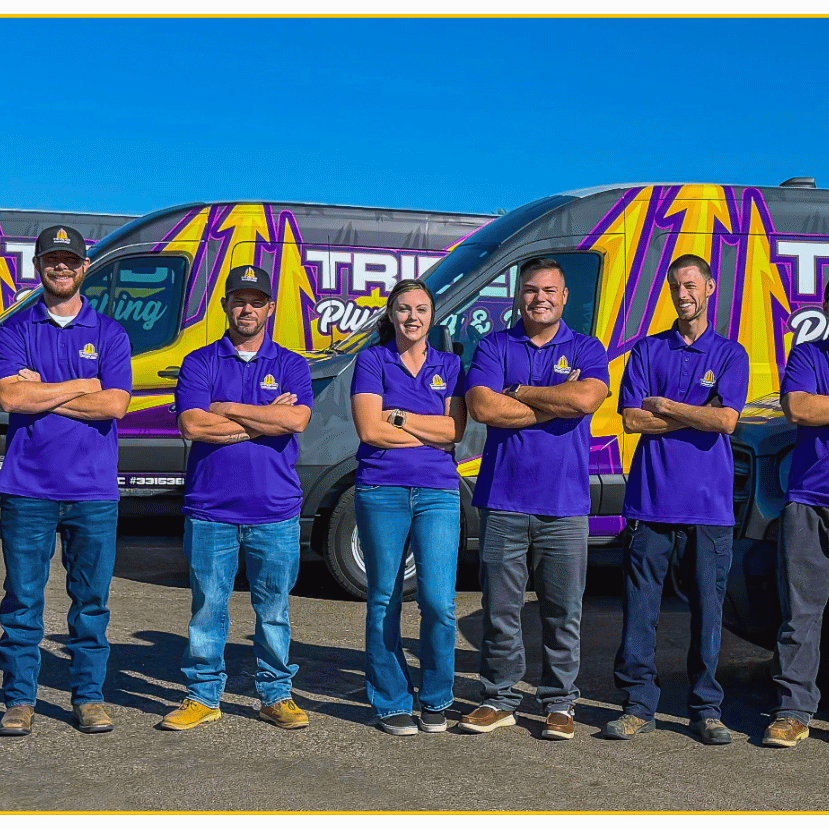 Trident Plumbing & Drain team standing in front of company service vehicles, proudly serving homeowners in Mesa AZ with professional plumbing and water heater services.