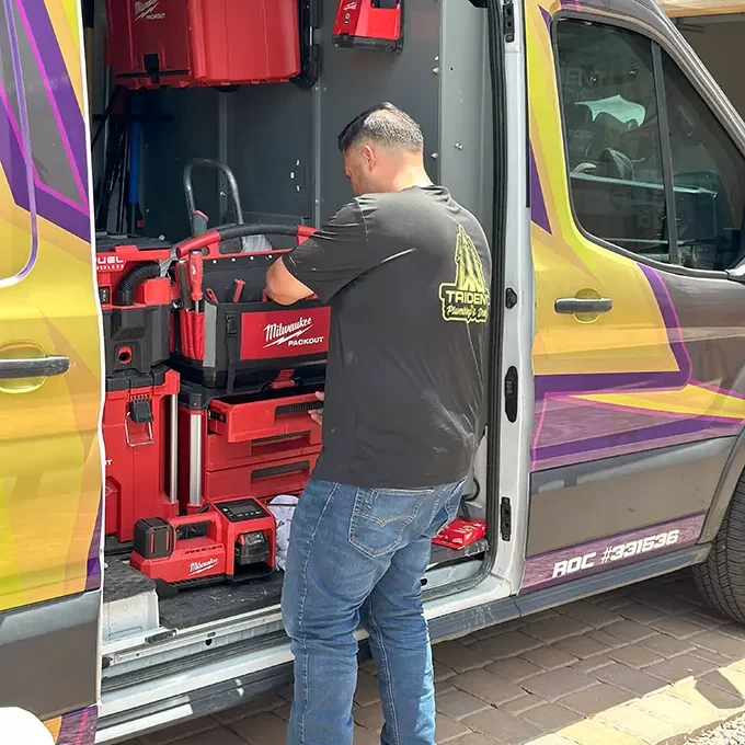 plumber arranging hydro jetting equipment