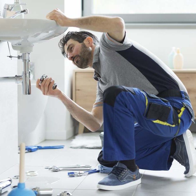 Plumber repairing a bathroom sink Scottsdale, AZ