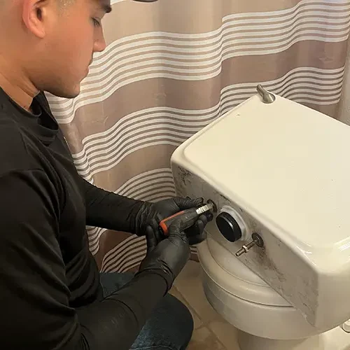 plumber repairing toilet