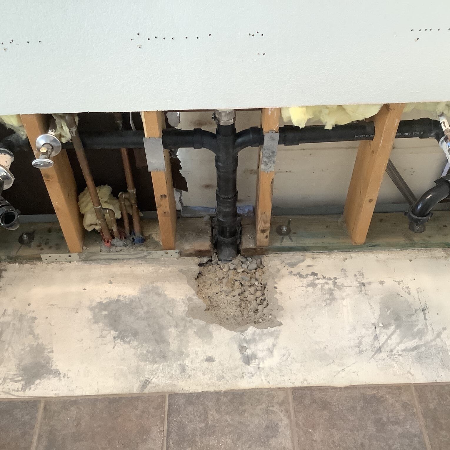 Exposed residential drain piping during a professional drain cleaning and plumbing inspection to prevent major drain backups