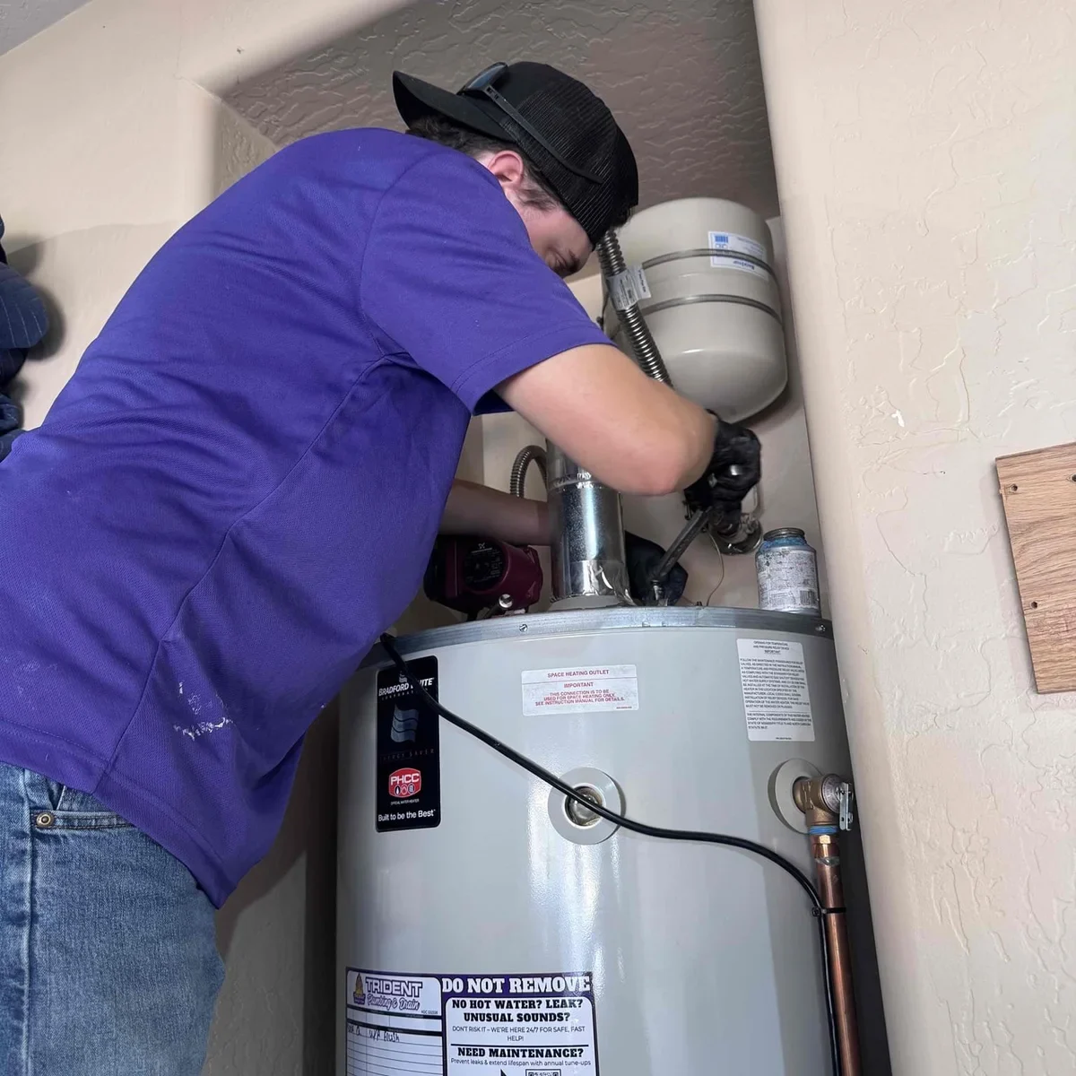 Trident Plumbing & Drain technician servicing a residential gas water heater in Eastmark, AZ.
